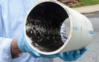 Large diameter plastic pipe with dark manganese deposits inside